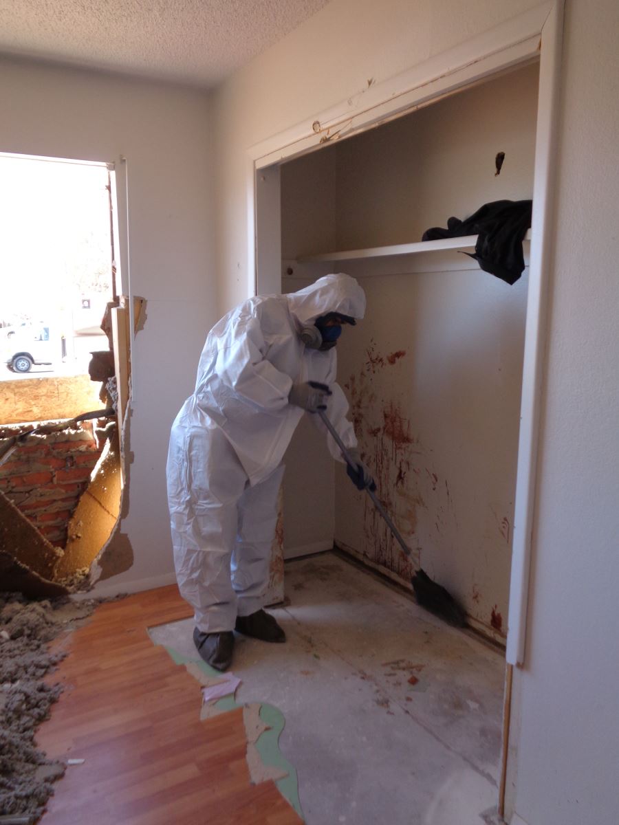 Person in biohazard suit cleaning