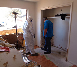 home_jd_18apr_disaster-640x480 (1)_300 Rockefeller's Cleaning and Restoration Restoration experts survey damage to rebuild an exterior wall that a police robot knocked down at this Northeast Heights home. Rockefeller's also cleaned toxic fumes from tear gas cannisters.