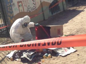 Hazmat crew cleans urine bottles out of alley